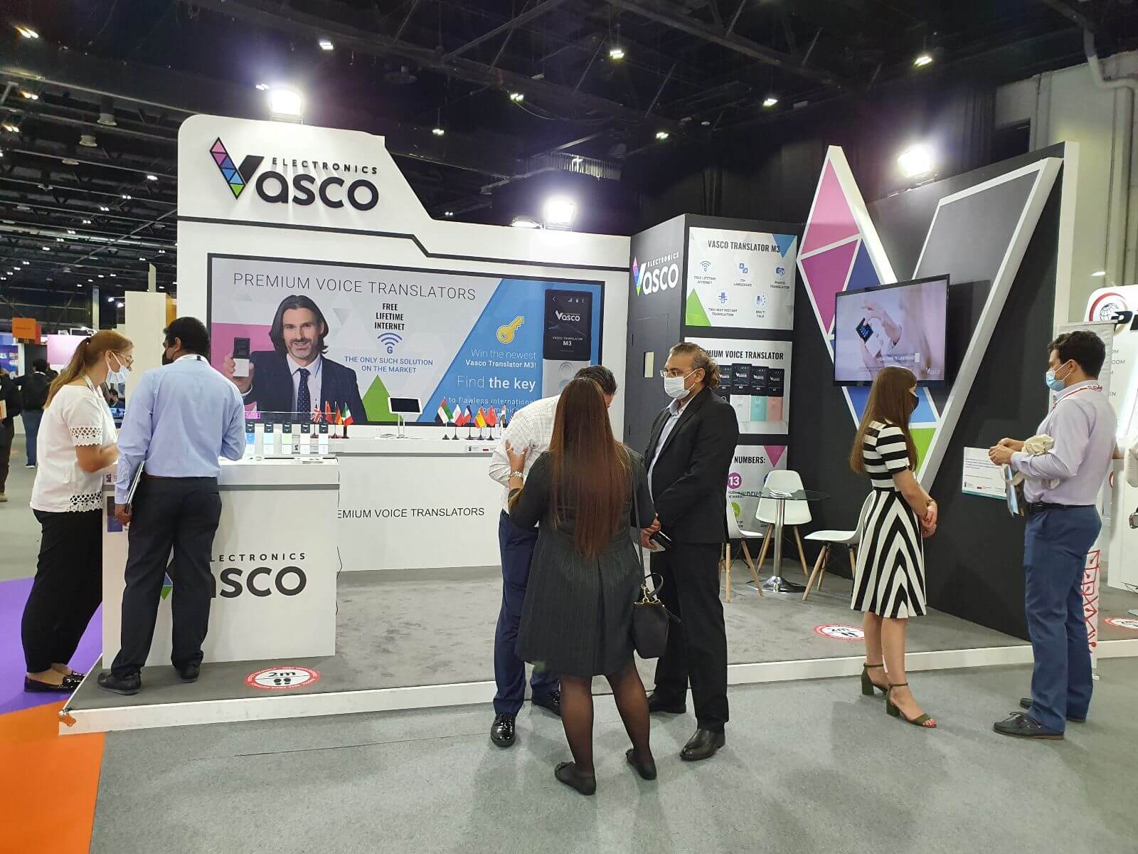 Vasco Electronics’s booth at GITEX with visitors in the foreground