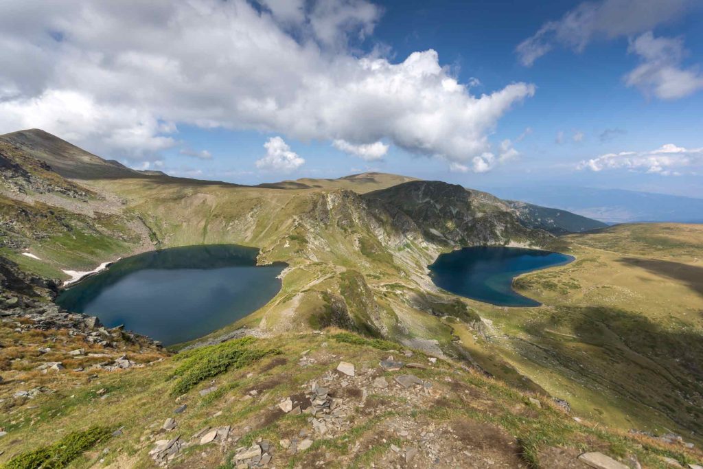 A picturesque view over small moutains and lakes.