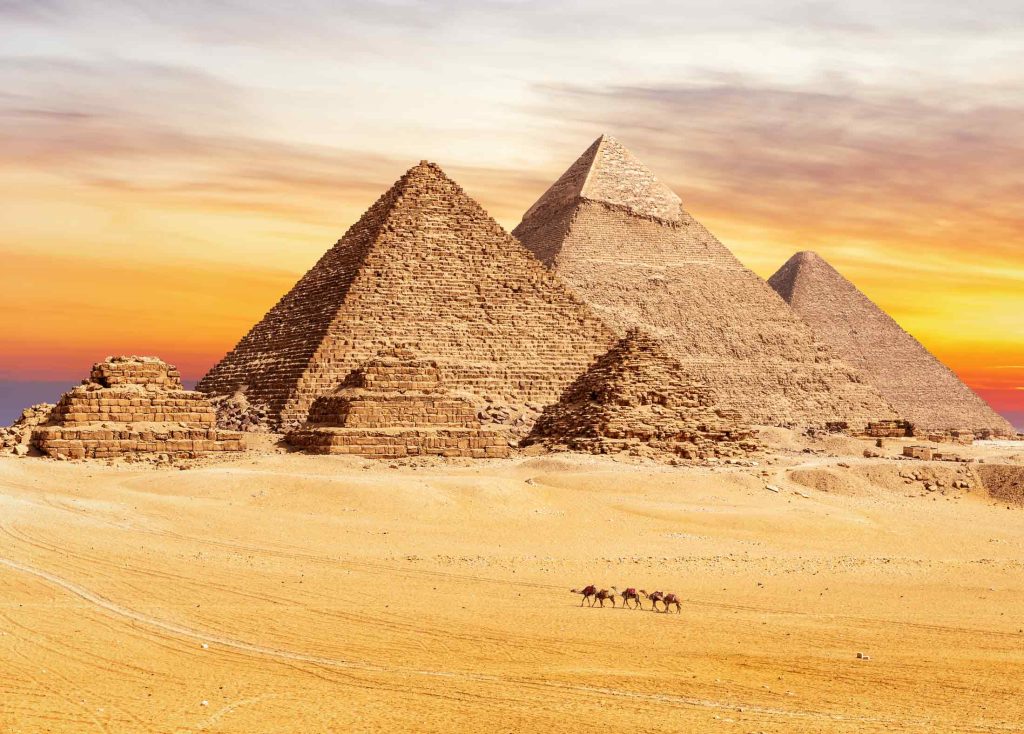 An image depicting the Pyramids during a sunset. 