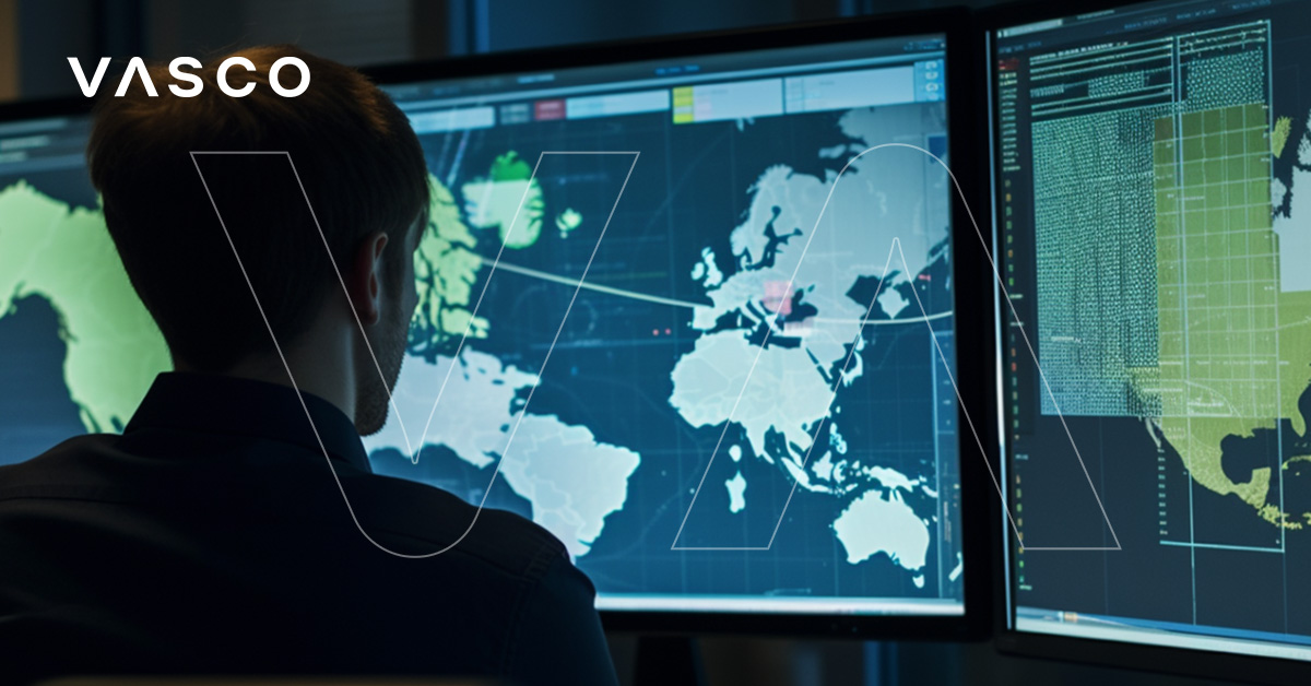 A person sitting in front of 2 large computer screens.