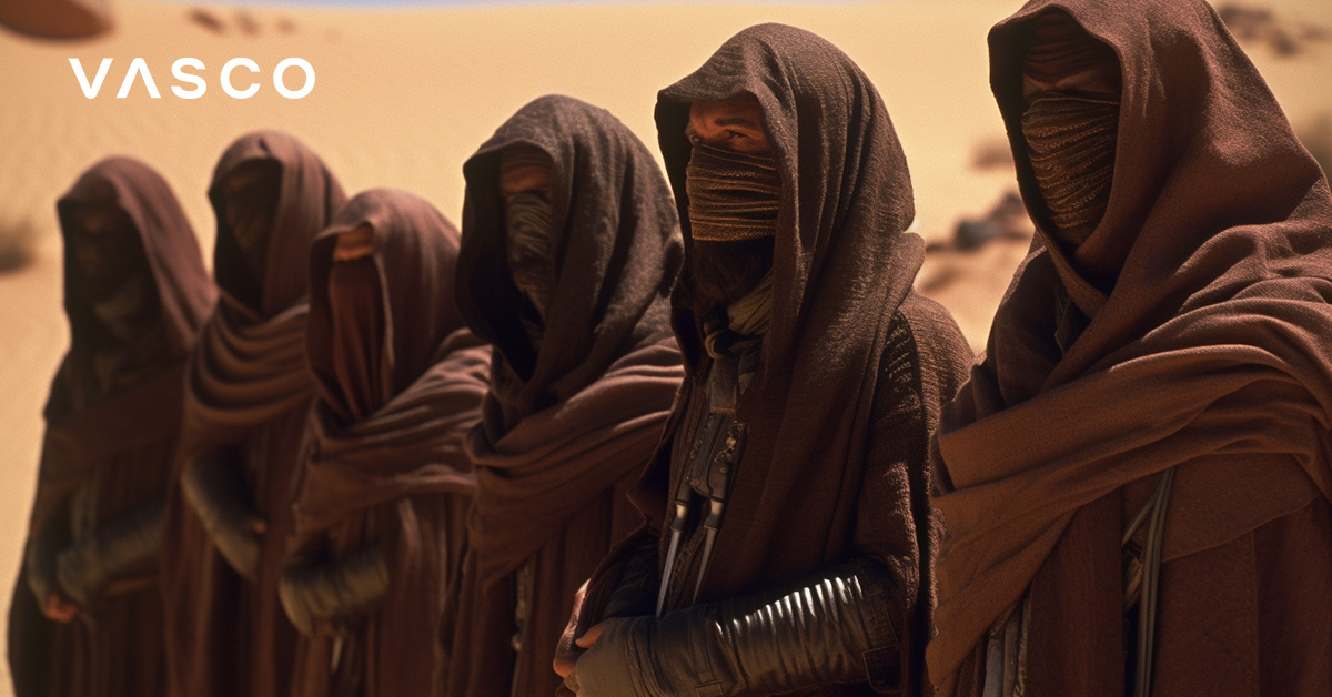 Hooded and masked Dune-like characters standing in a row.