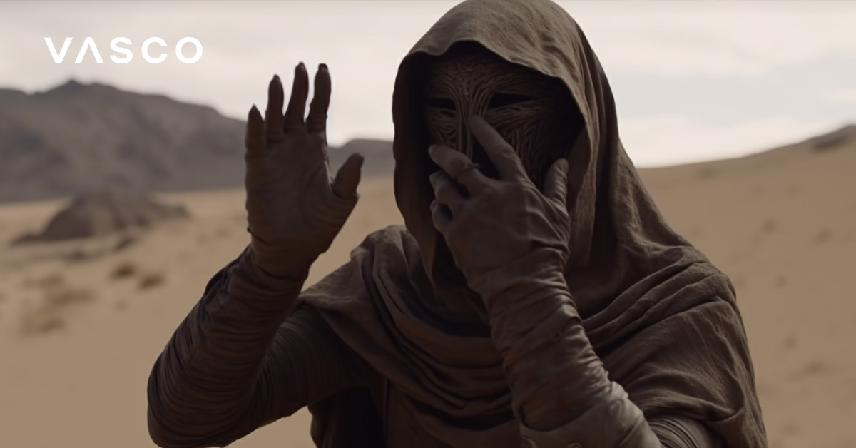 A hooded and masked Dune-like character using gestures to communicate.