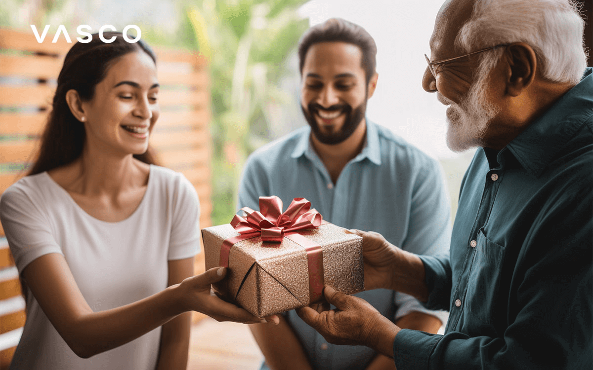 A young woman is receiving the gift from an elderly man.