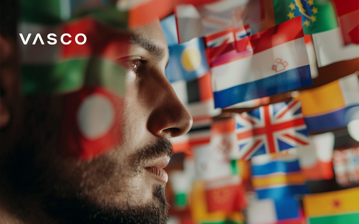 A bearden man looking at countries flags.