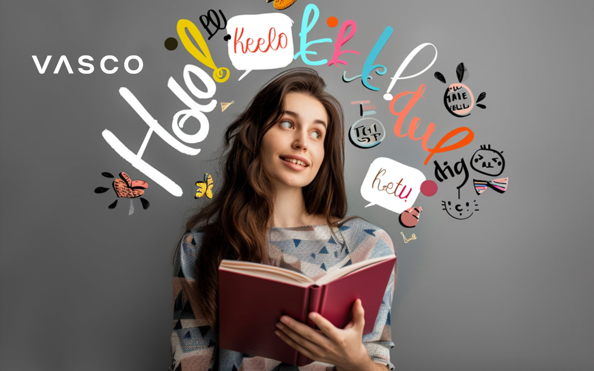 A young woman reading a book with letter symbols around her.