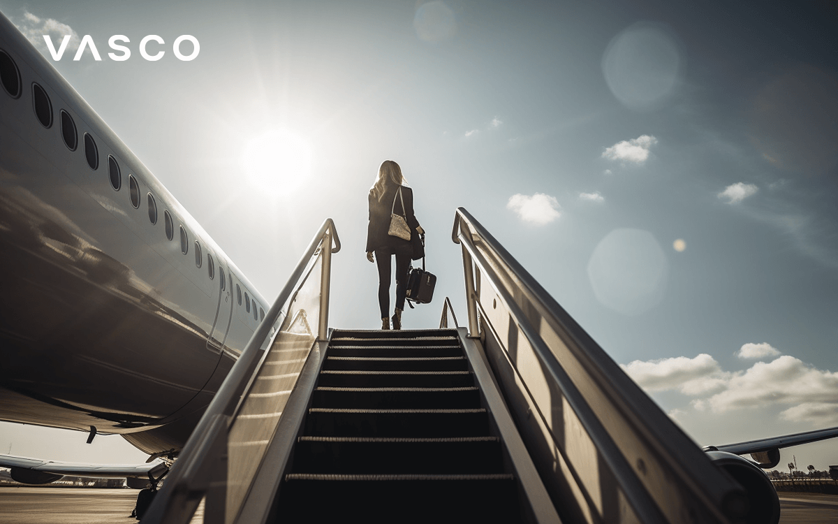 Woman with luggage taking a stairway leading to the airplane