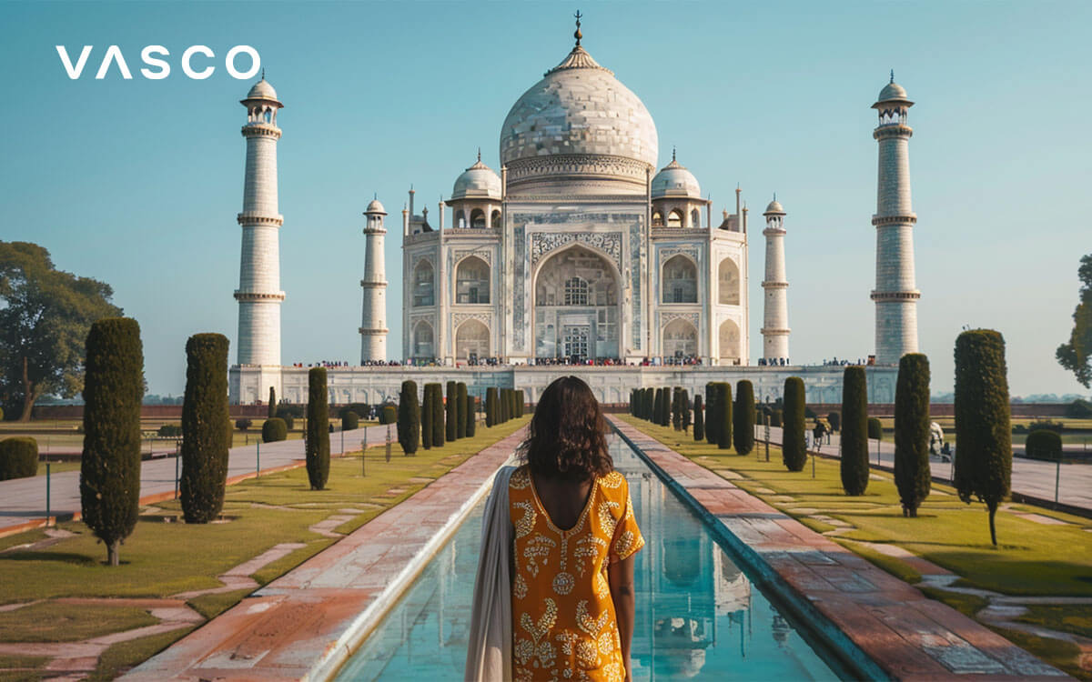 A woman standing in front of Taj Mahal.