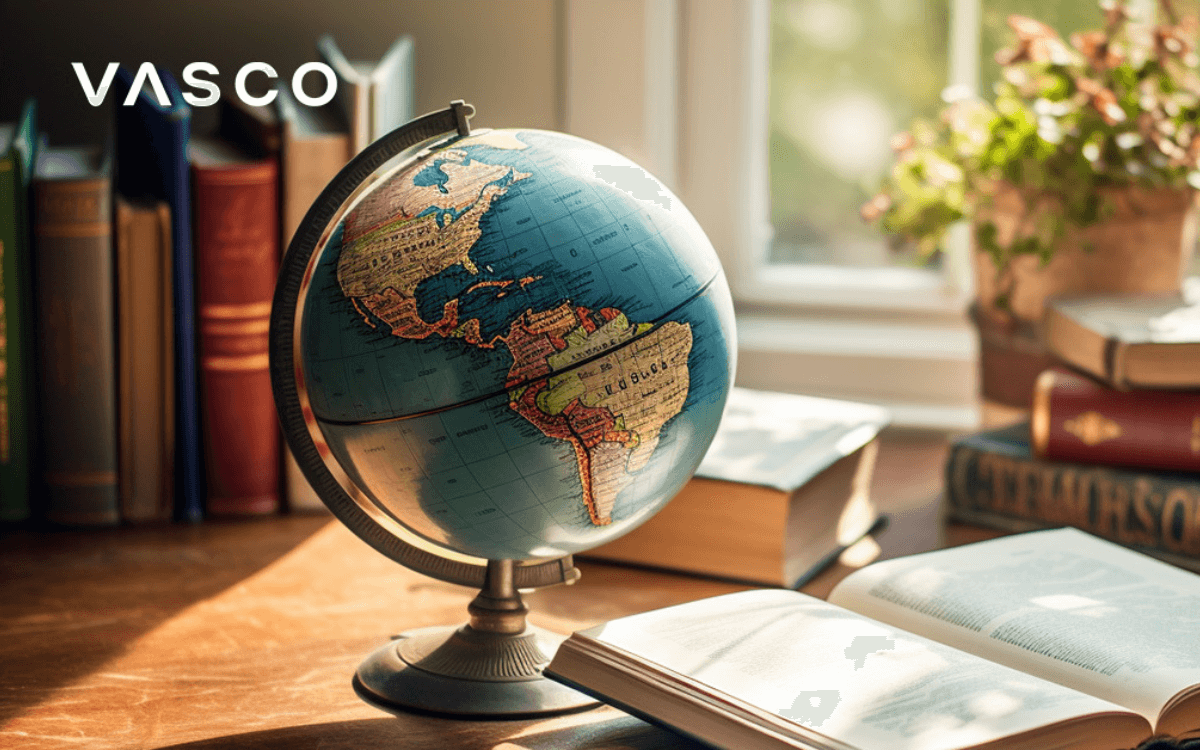 A globe on the desk next to the book.