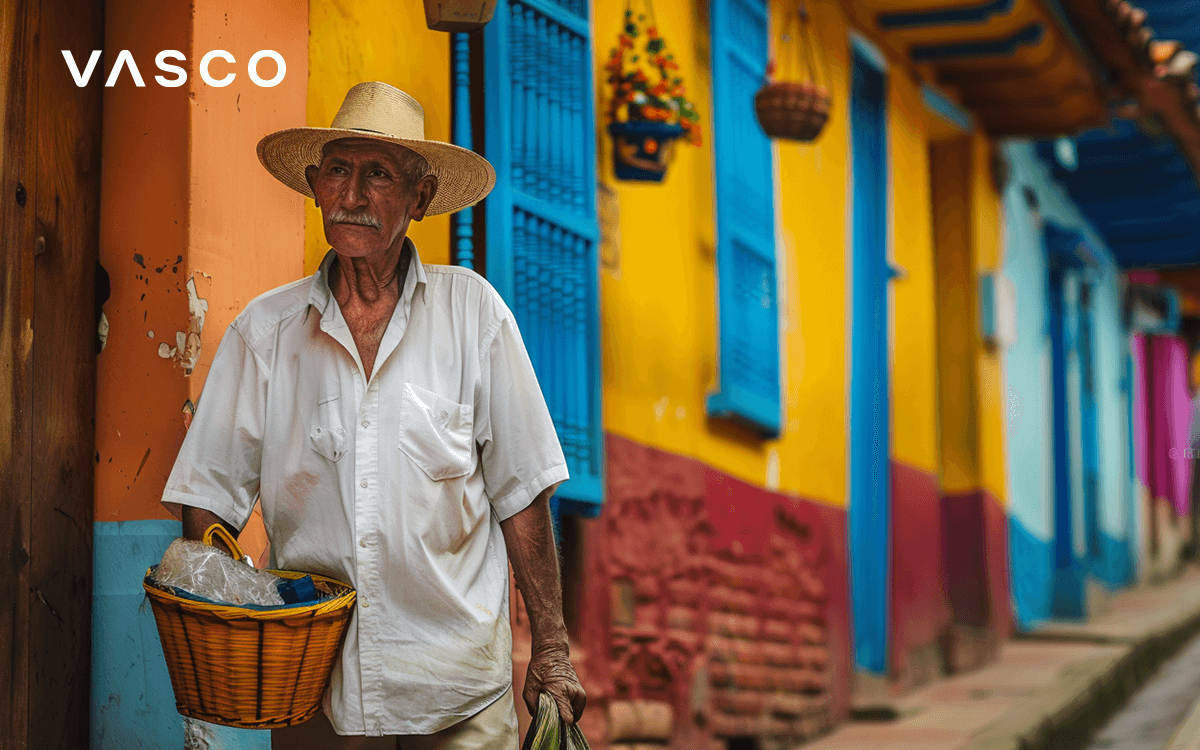 A local citizen is standing among colorful houses. 