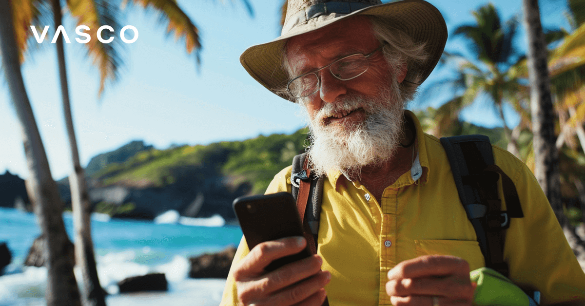 An elderly man checking his phone by the exotic beach.