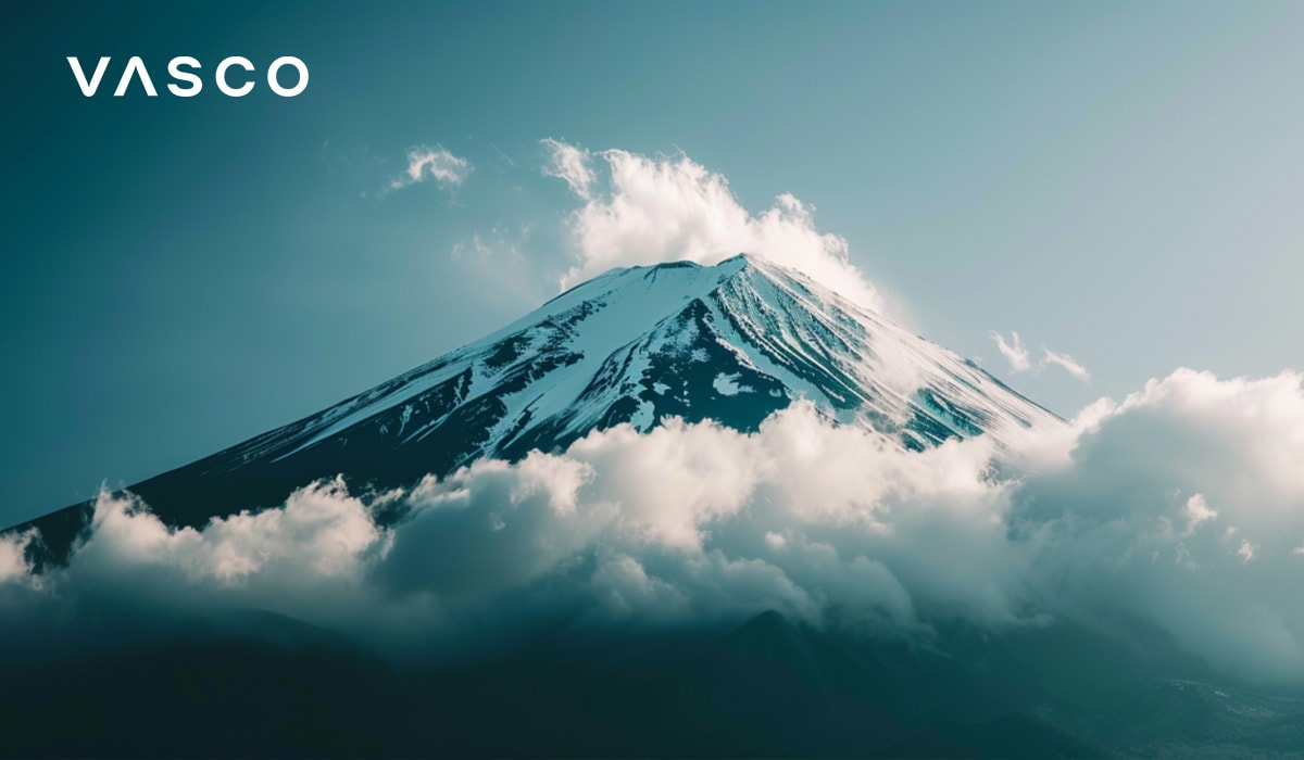 A majestic view of Mount Fuji with clouds partially covering its snow-capped peak.