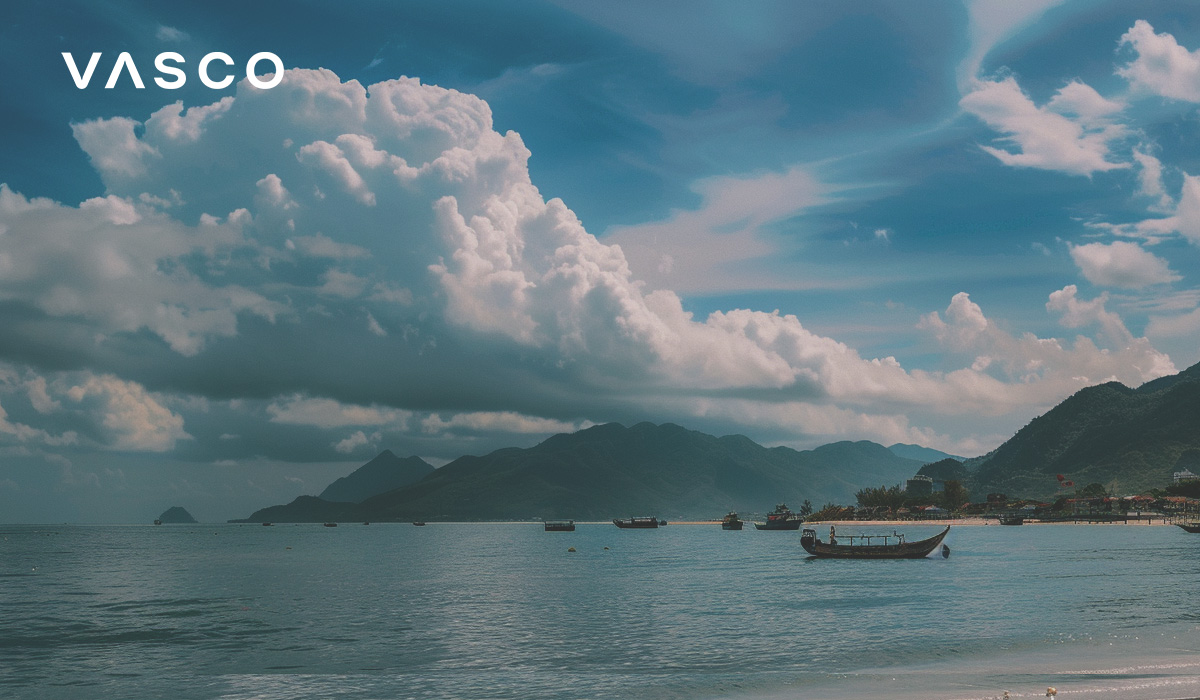 A beach with boats and mountains in the background, illustrating the best time to go to Vietnam.