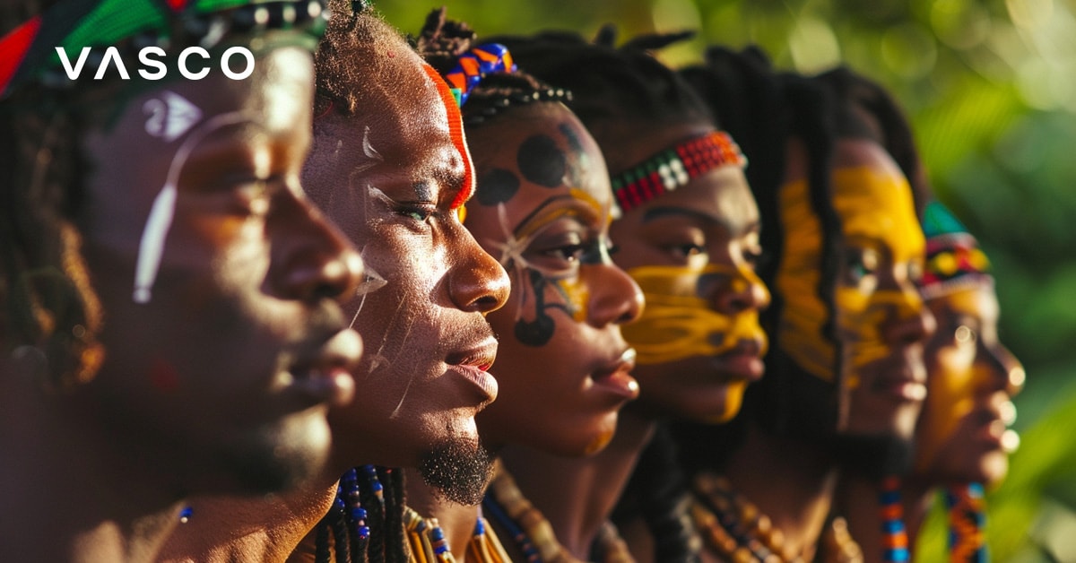 A group of people in traditional attire with colorful face paint, standing side by side and looking in the same direction.