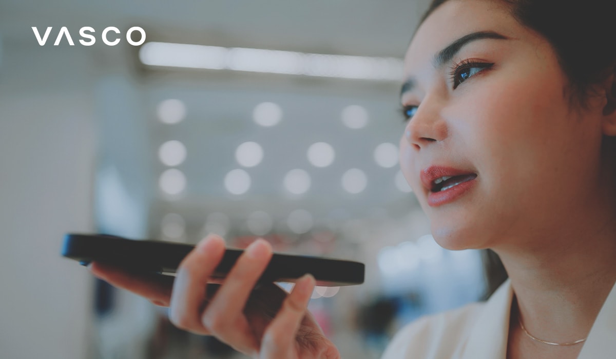 Young lady holding an electronic translator device, speaking and translating to different languages.