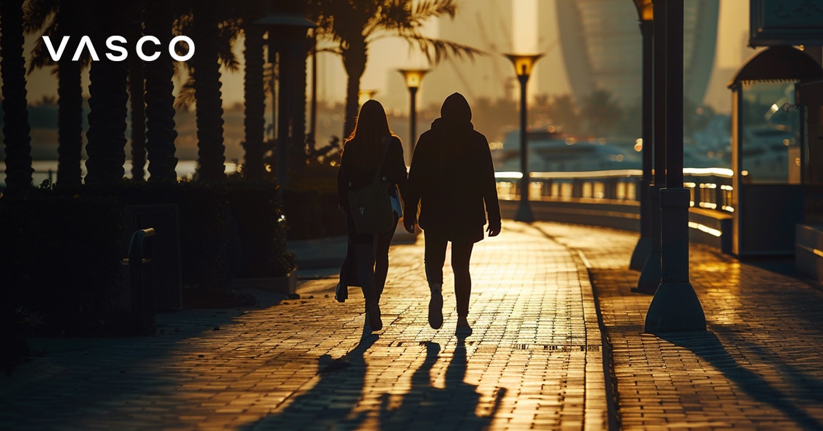 Couple walking along Dubai Marina promenade at sunset
