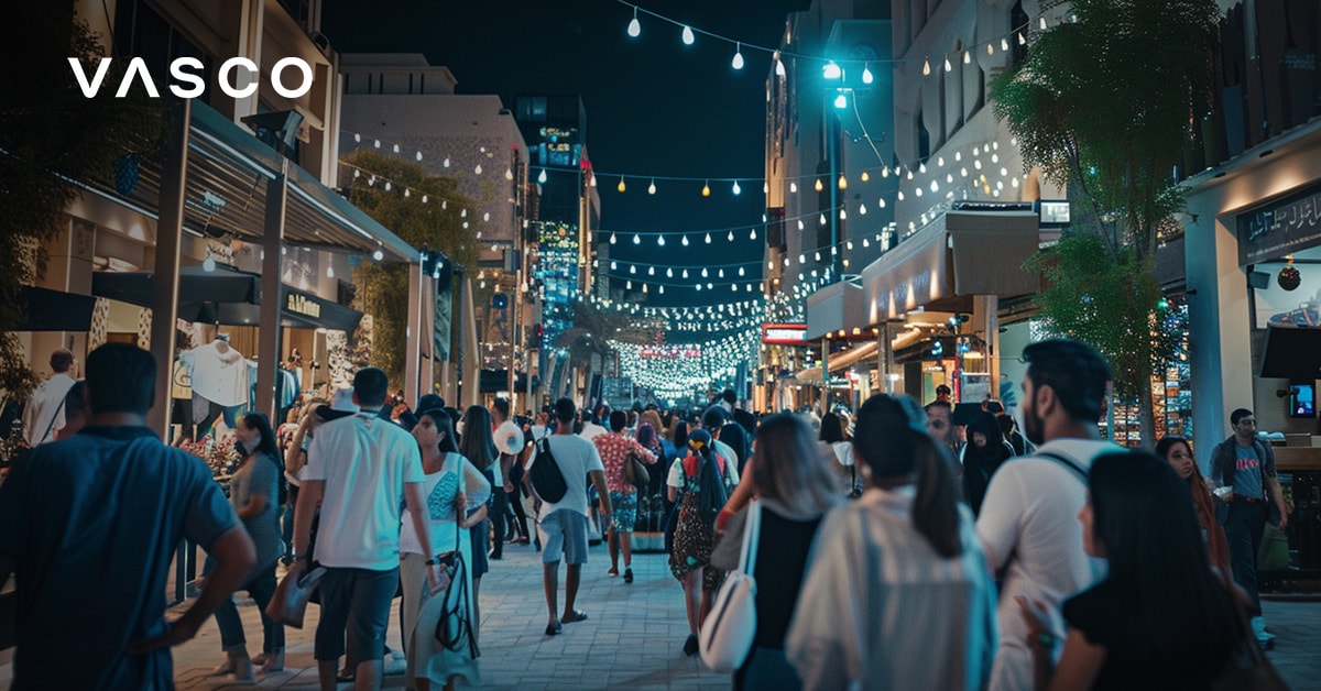 Busy night market in Dubai with people shopping and lights overhead