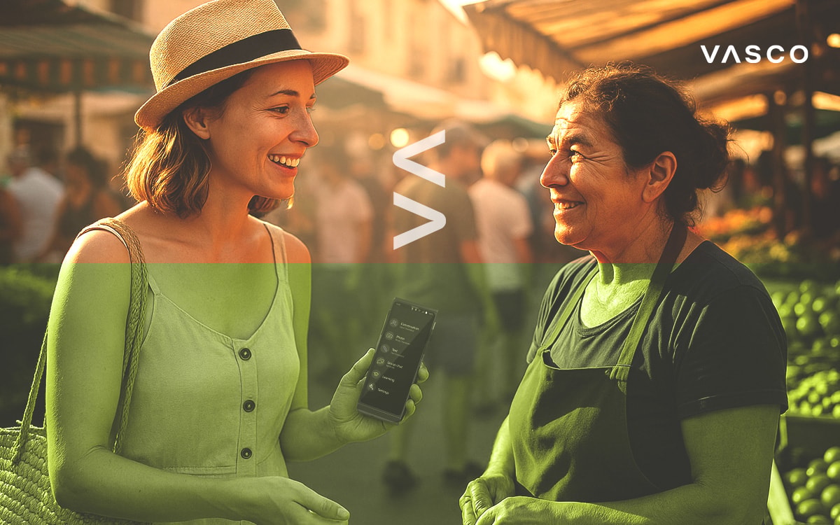 A smiling traveler shows a translation device to a local market vendor during a cheerful conversation.