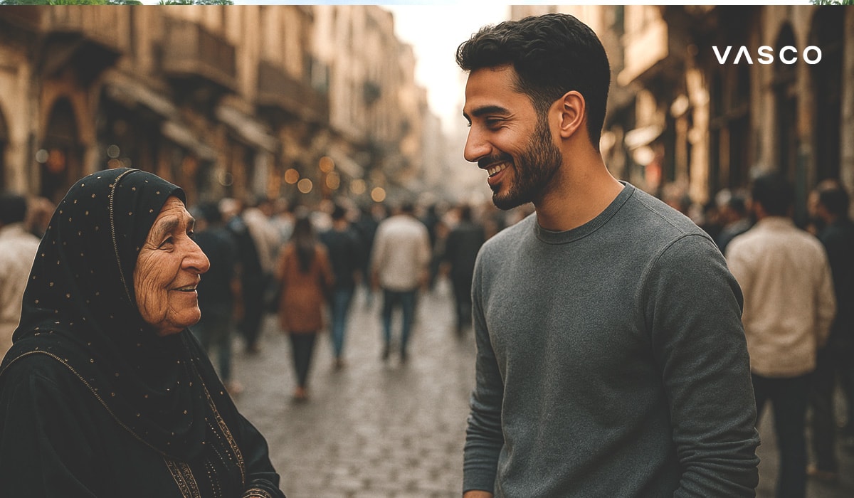Elderly woman in traditional clothing and a young man talking on a crowded street