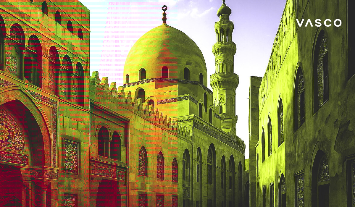 Golden mosque architecture with a dome and minaret illuminated by sunlight