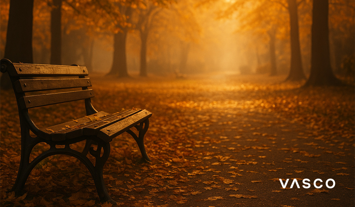 autumn park bench surrounded by golden leaves in soft morning light
