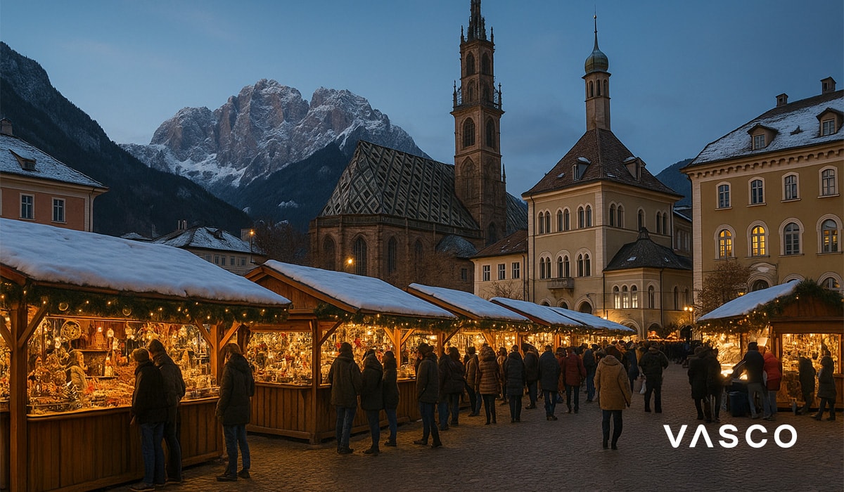 Italian Christmas market with alpine mountains at dusk