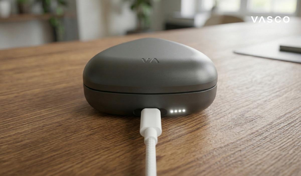 vasco translator earbuds charging case with cable on wooden desk