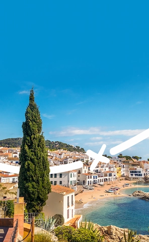 View of the coastline and nearby town in Fang Aventura, Girona — featuring rugged cliffs, blue waters, and scenic urban surroundings.