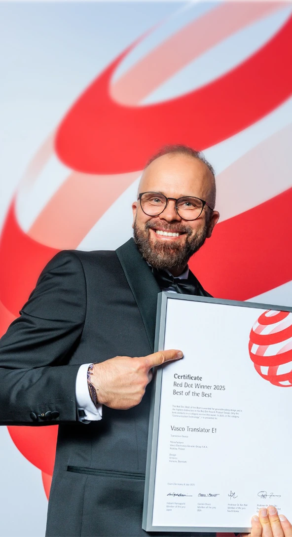 The CEO of Vasco Electronics holding the Red Dot award, showcasing the award-winning devices.
